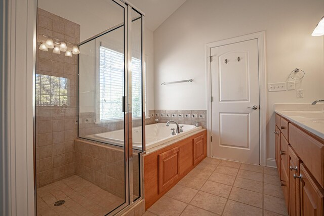 full bath featuring a garden tub, tile patterned flooring, vaulted ceiling, vanity, and a shower stall