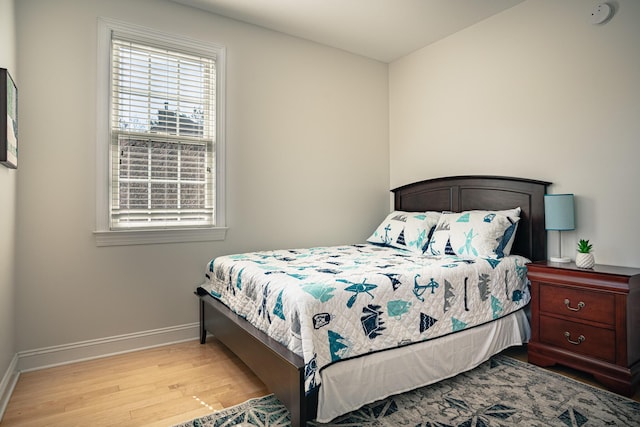 bedroom featuring wood finished floors and baseboards