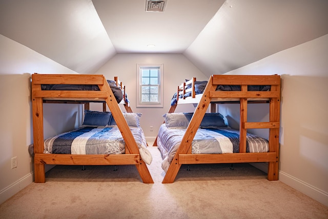 bedroom with carpet floors, lofted ceiling, visible vents, and baseboards