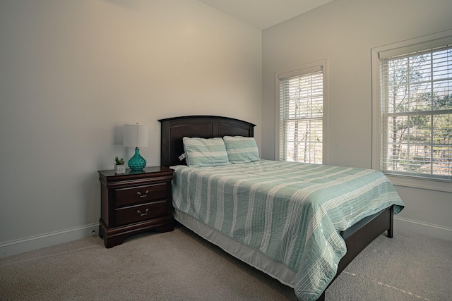 bedroom featuring carpet floors and baseboards