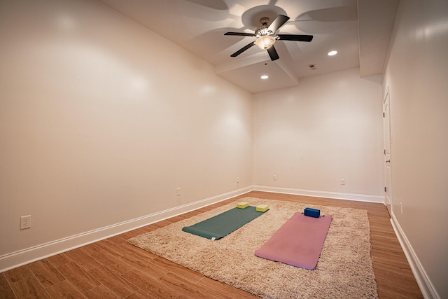 exercise room with visible vents, baseboards, wood finished floors, and recessed lighting