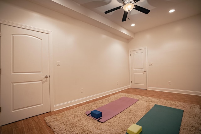 workout room with a ceiling fan, baseboards, wood finished floors, and recessed lighting