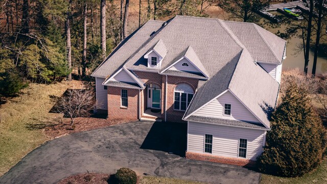 view of front of home with aphalt driveway and brick siding