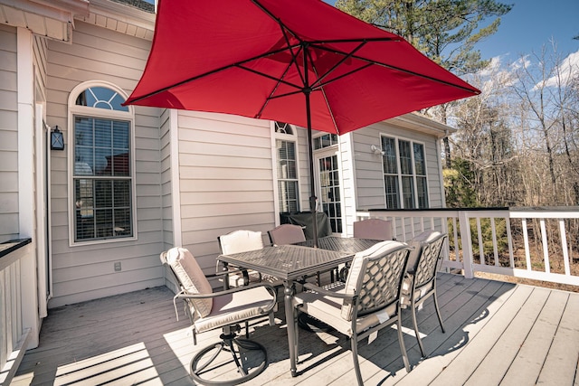 wooden terrace with outdoor dining space