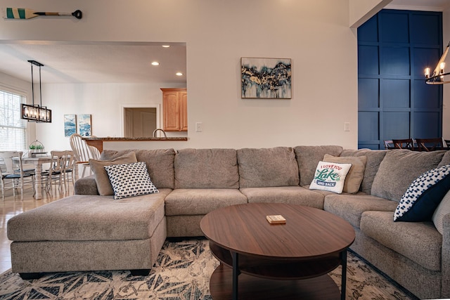 living area with a chandelier, recessed lighting, and light wood-style flooring