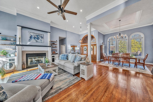 20 Waverly Ct, Moneta, VA 24121 - living room featuring ceiling fan with notable chandelier, a glass covered fireplace, wood finished floors, recessed lighting, and crown molding