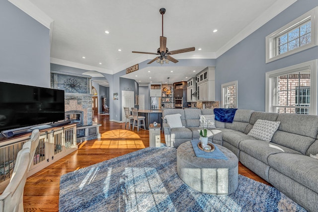 20 Waverly Ct, Moneta, VA 24121 - living room featuring a stone fireplace, ceiling fan, ornamental molding, and light wood finished floors