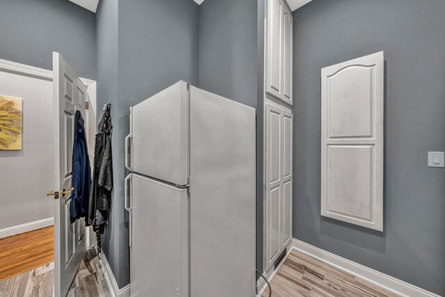 20 Waverly Ct, Moneta, VA 24121 - kitchen with white cabinetry, light wood-type flooring, freestanding refrigerator, and baseboards
