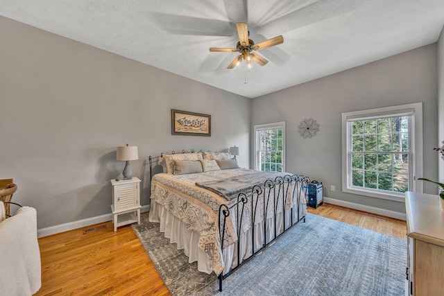 20 Waverly Ct, Moneta, VA 24121 - bedroom with light wood-type flooring, baseboards, a textured ceiling, and a ceiling fan