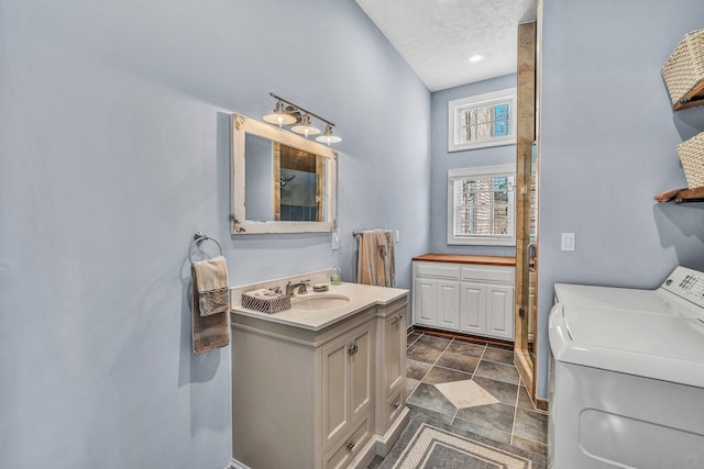 20 Waverly Ct, Moneta, VA 24121 - bathroom with vanity, washer / dryer, a shower stall, stone finish floor, and a textured ceiling