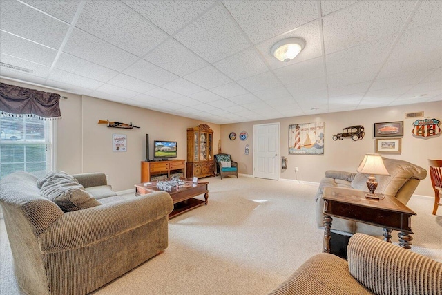 living room with visible vents, carpet floors, a paneled ceiling, and baseboards