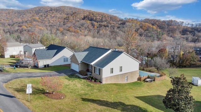 drone / aerial view featuring a wooded view