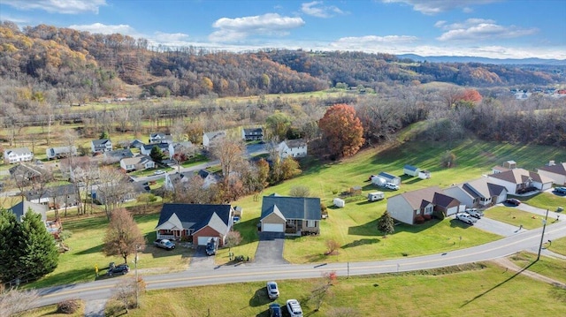 aerial view featuring a residential view and a wooded view