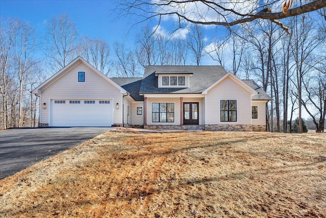 modern farmhouse style home with a garage, aphalt driveway, and roof with shingles