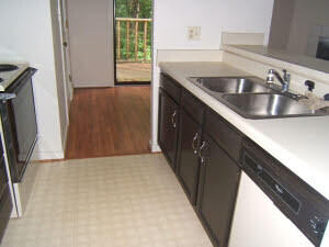 kitchen featuring light floors, range with electric cooktop, a sink, light countertops, and dishwasher