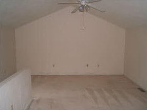 bonus room with a ceiling fan