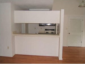 kitchen with wood finished floors and white cabinetry