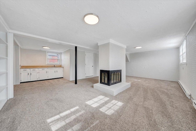 unfurnished living room featuring a healthy amount of sunlight, a fireplace, and carpet flooring