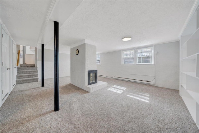 below grade area with brick wall, stairway, a textured ceiling, carpet floors, and a baseboard heating unit