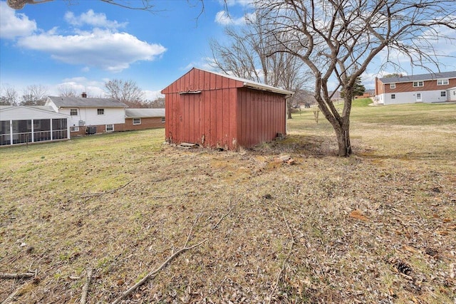 view of yard with a sunroom and an outdoor structure