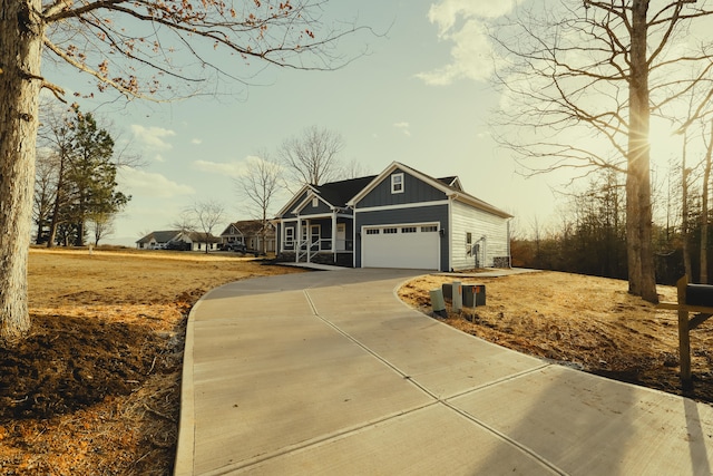 view of front of home featuring board and batten siding, driveway, and an attached garage