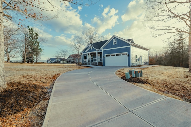 view of front of property with board and batten siding, concrete driveway, stone siding, and a garage