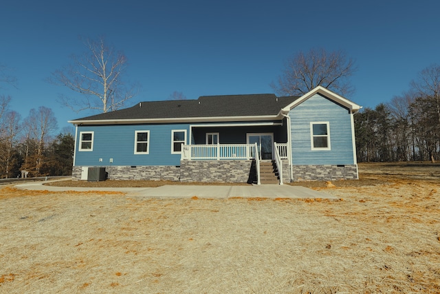 back of house with covered porch, crawl space, and cooling unit