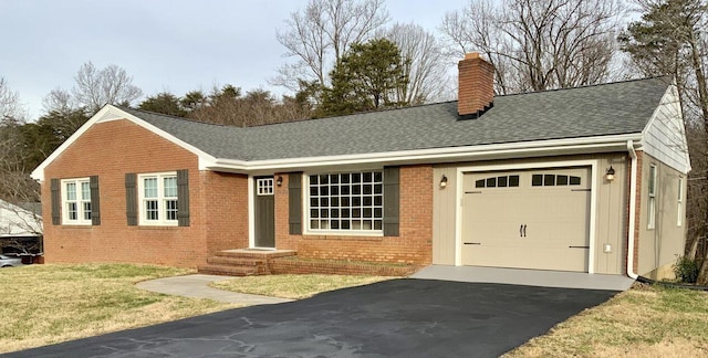 ranch-style house with an attached garage, brick siding, driveway, roof with shingles, and a chimney