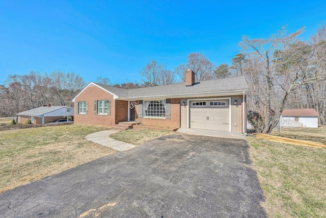 ranch-style house featuring brick siding, a front yard, a chimney, a garage, and driveway