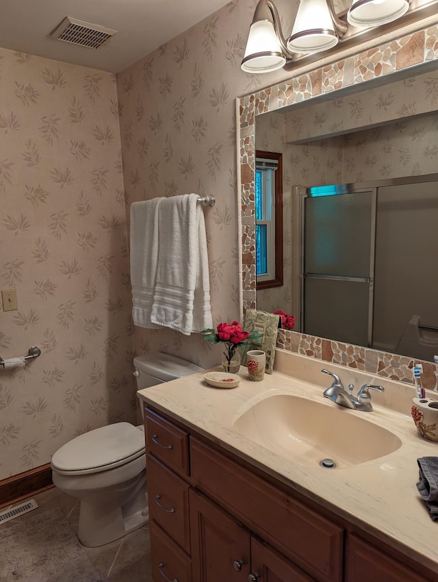 bathroom with toilet, vanity, visible vents, and wallpapered walls