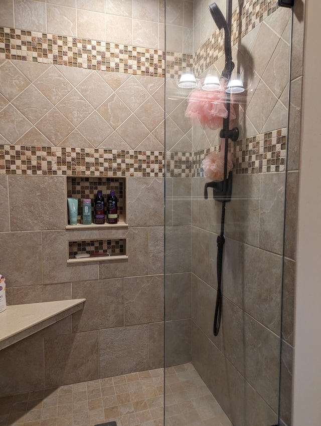 bathroom with tiled shower