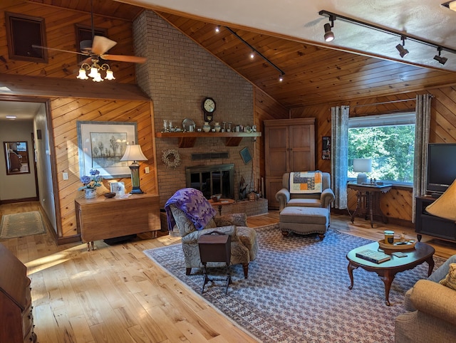 living area with a brick fireplace, wood ceiling, wood walls, and hardwood / wood-style flooring