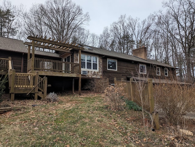 back of house featuring stairway, a shingled roof, a chimney, and a wooden deck