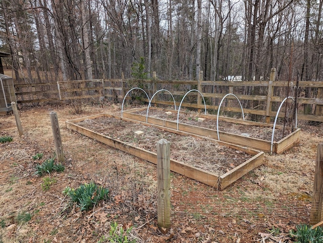 view of yard with a vegetable garden and fence