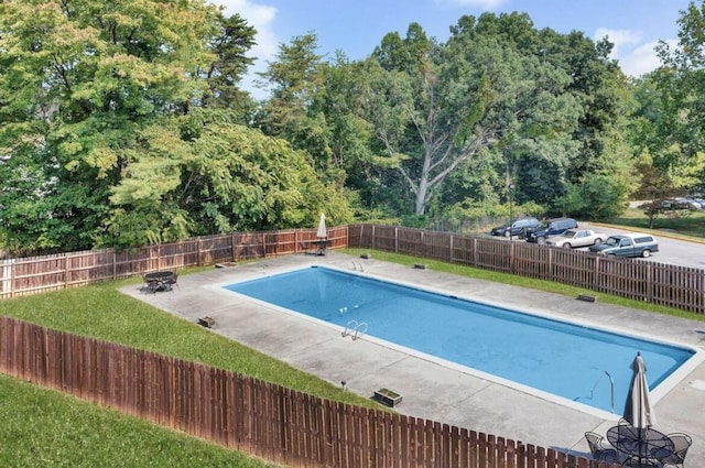 view of pool with a lawn, a patio area, a fenced backyard, and a fenced in pool