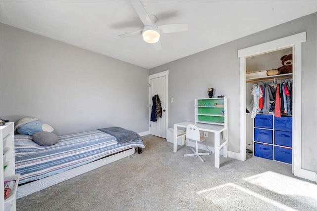 carpeted bedroom with a closet, a ceiling fan, and baseboards