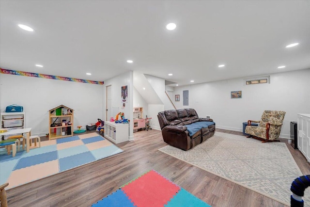 game room with baseboards, wood finished floors, and recessed lighting