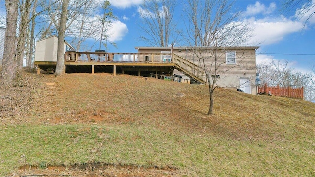 back of property featuring stairway and a deck