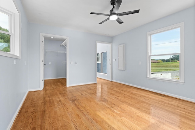 47 Westover Rd, Rocky Mount, VA 24151 - unfurnished bedroom featuring a ceiling fan, a walk in closet, baseboards, and light wood finished floors