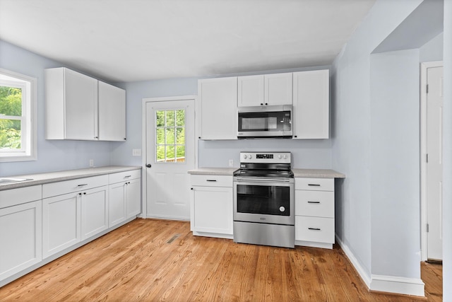 47 Westover Rd, Rocky Mount, VA 24151 - kitchen with stainless steel appliances, light wood-type flooring, light countertops, and white cabinets