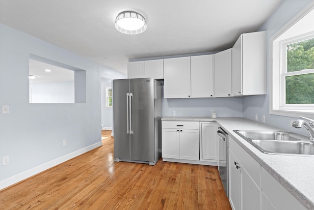 47 Westover Rd, Rocky Mount, VA 24151 - kitchen featuring a sink, white cabinetry, light wood-style floors, light countertops, and appliances with stainless steel finishes