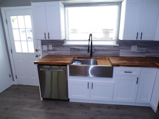 kitchen with plenty of natural light, a sink, wood counters, and stainless steel dishwasher