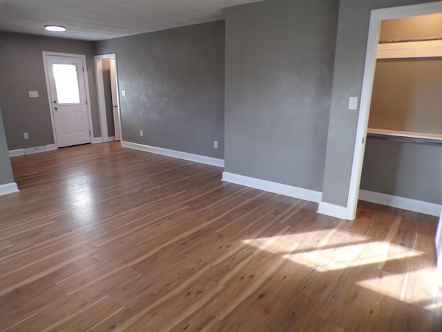 interior space featuring baseboards and wood finished floors