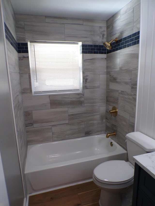 full bath with toilet, shower / washtub combination, wood finished floors, and vanity