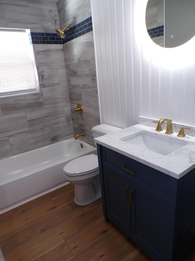 bathroom featuring vanity, shower / bathing tub combination, wood finished floors, and toilet