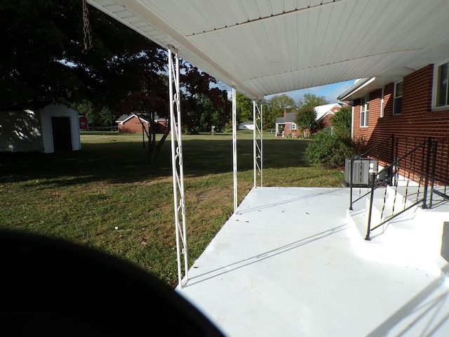 view of patio / terrace featuring a shed, central AC unit, and an outdoor structure