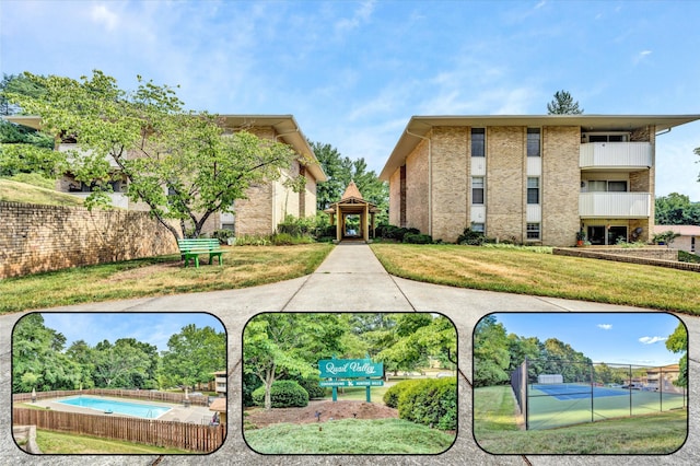 view of community with a yard and fence