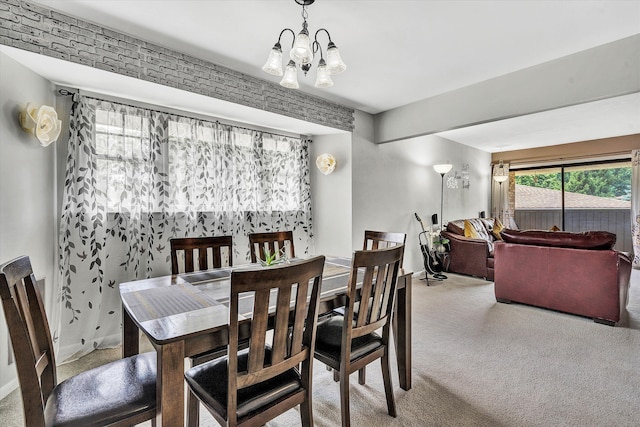 carpeted dining room with a chandelier