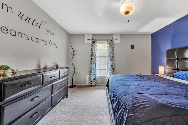 bedroom featuring baseboards, a ceiling fan, and light colored carpet