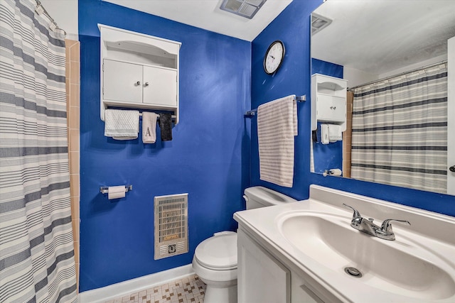 bathroom featuring toilet, vanity, baseboards, visible vents, and heating unit